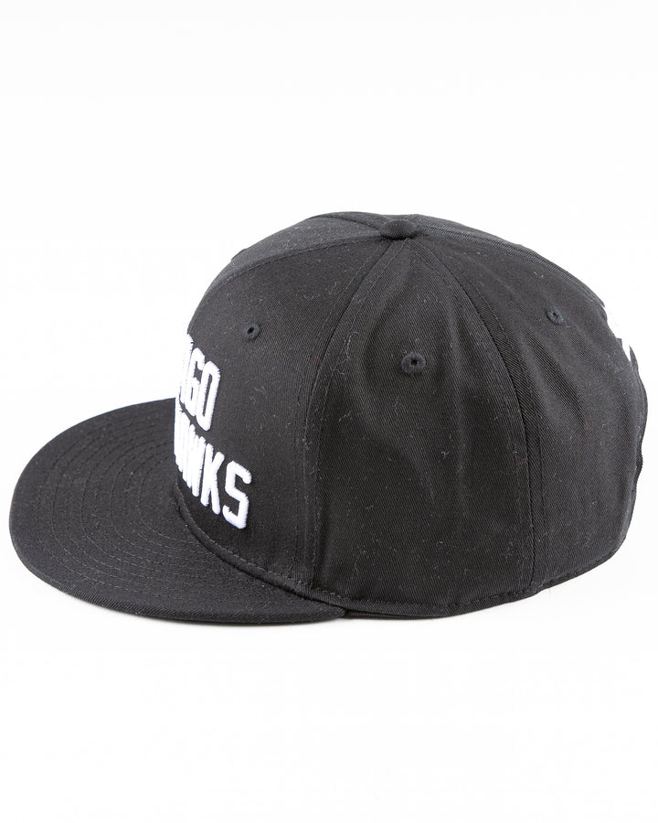 black Starter flat brim snapback with Chicago Blackhawks wordmark embroidered on front - left side lay flat