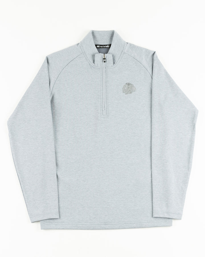 heather grey TravisMathew quarter zip with Chicago Blackhawks primary logo on left chest - front lay flat