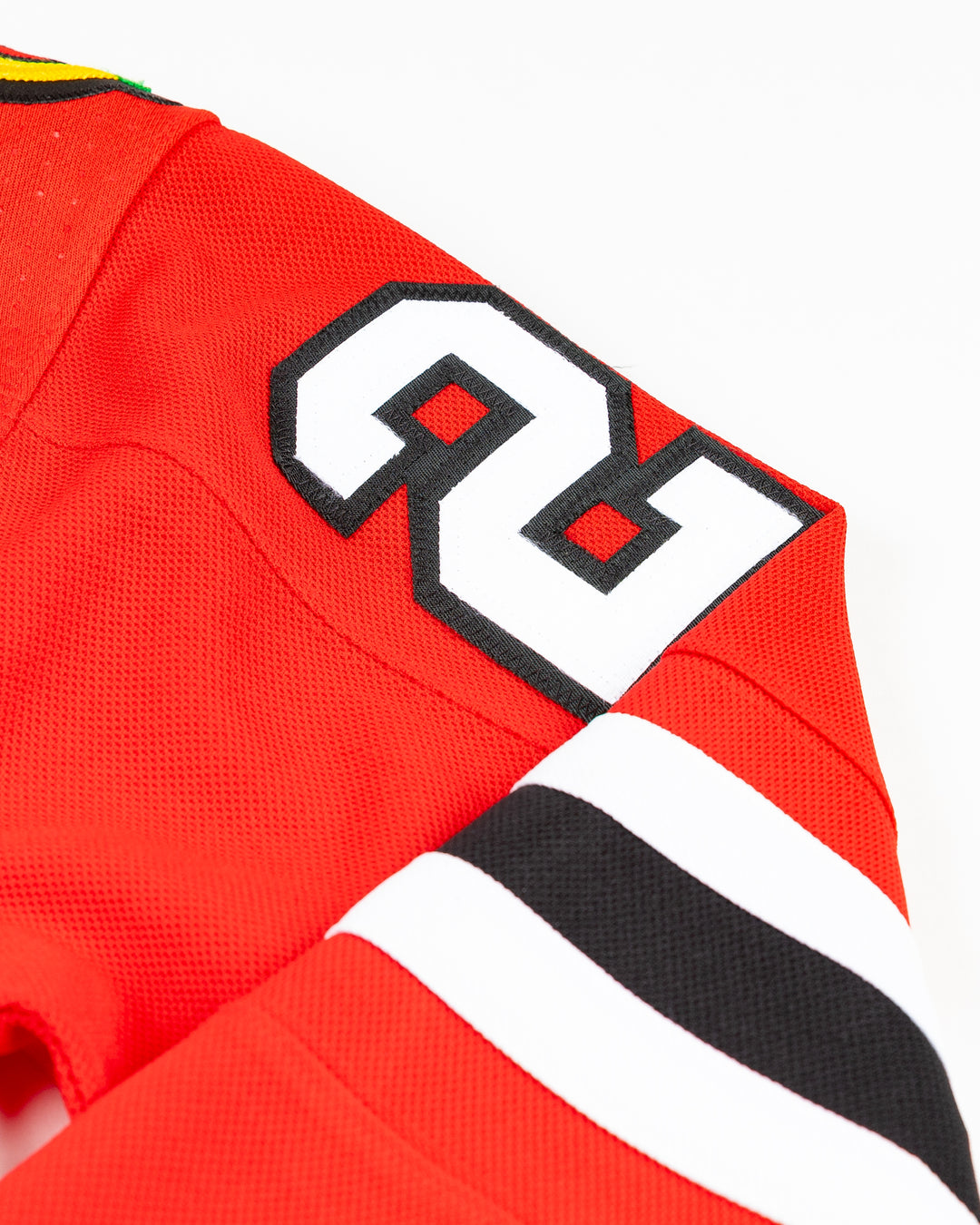 red adidas Chicago Blackhawks jersey with Lukas Reichel name and number stitched - shoulder detial lay flat