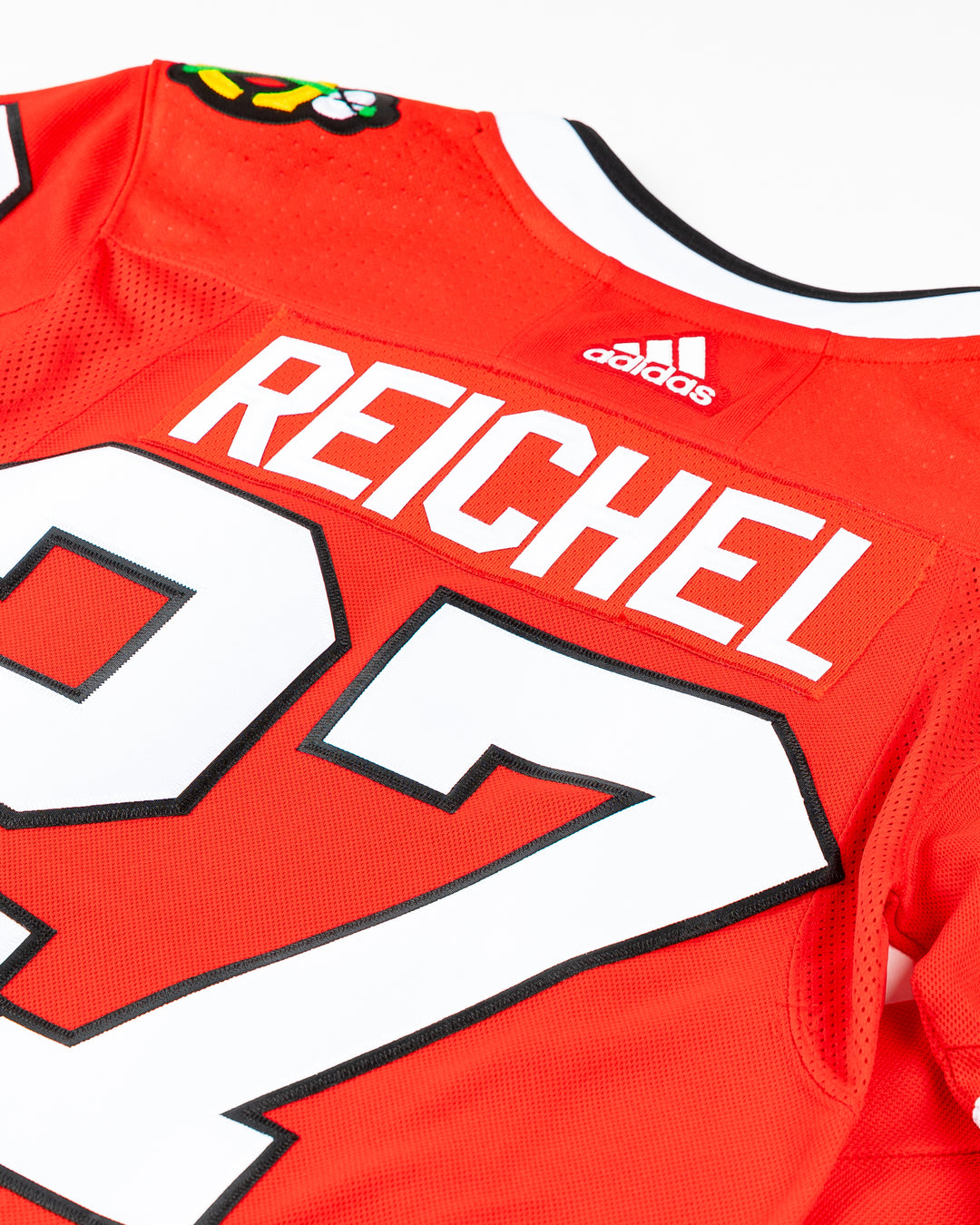 red adidas Chicago Blackhawks jersey with Lukas Reichel name and number stitched - back detail lay flat