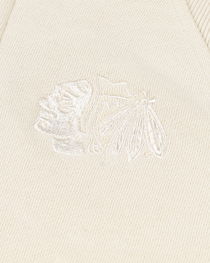 cream colored lululemon cropped ladies half zip with tonal Chicago Blackhawks primary logo embroidered on left chest - detail lay flat