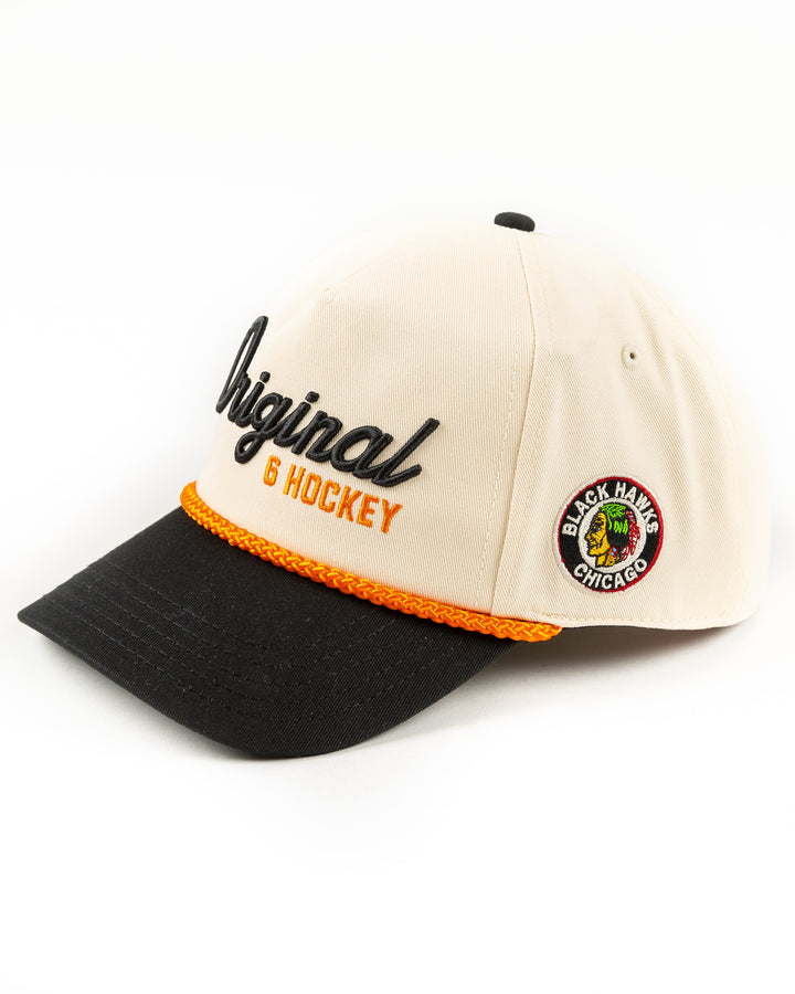 beige, black and orange snapback rope hat with Original Six hockey word graphic across front and vintage Chicago Blackhawks logo embroidered on left side - left angle lay flat