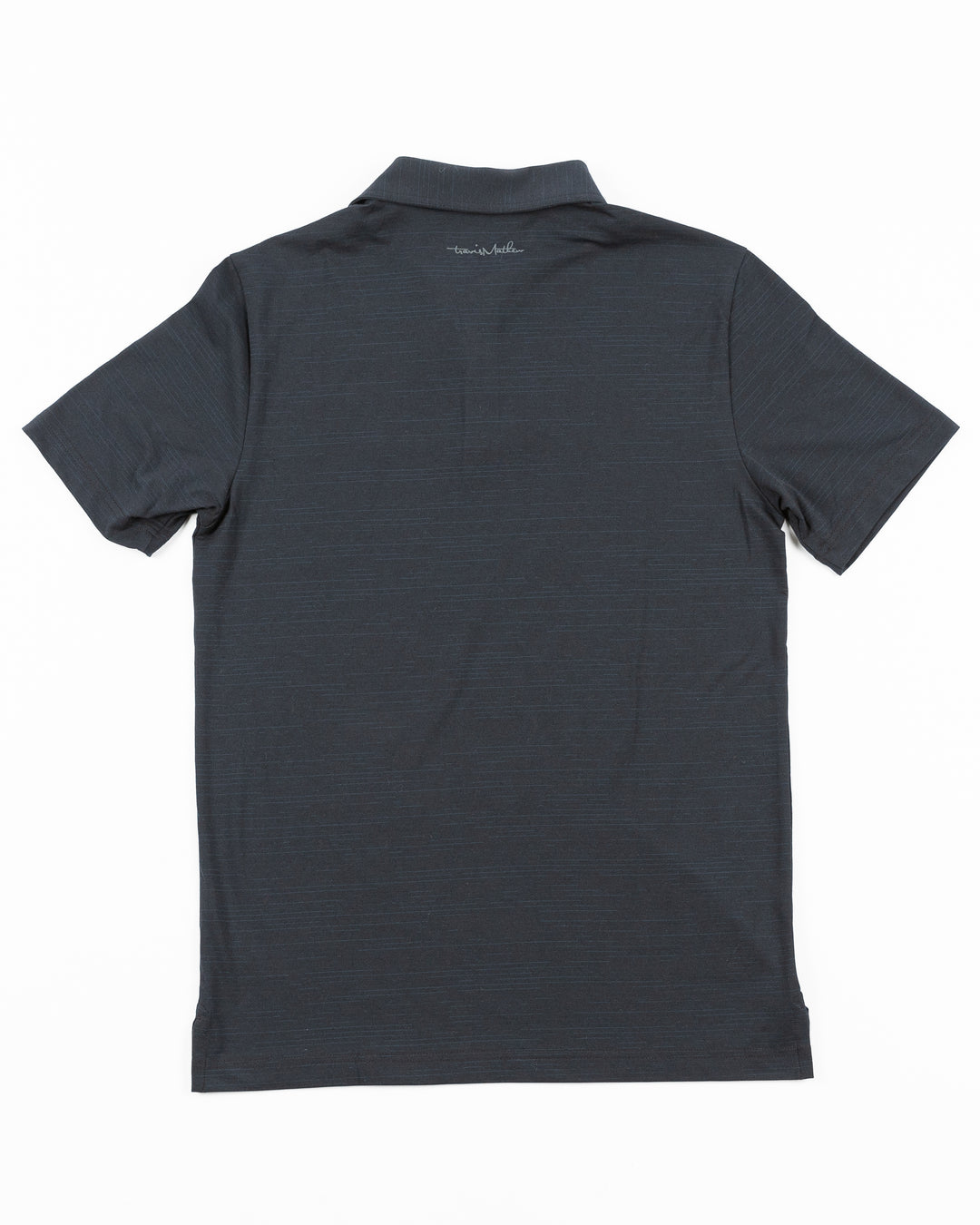 black TravisMathew polo with Chicago Blackhawks tonal primary logo embroidered on left chest - back lay flat