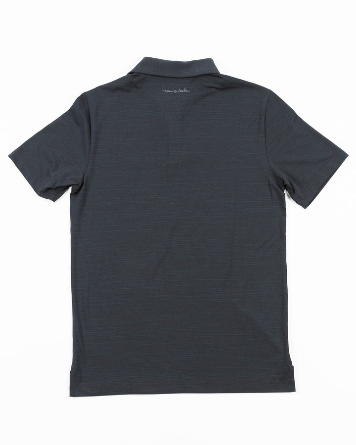 black TravisMathew polo with Chicago Blackhawks tonal primary logo embroidered on left chest - back lay flat