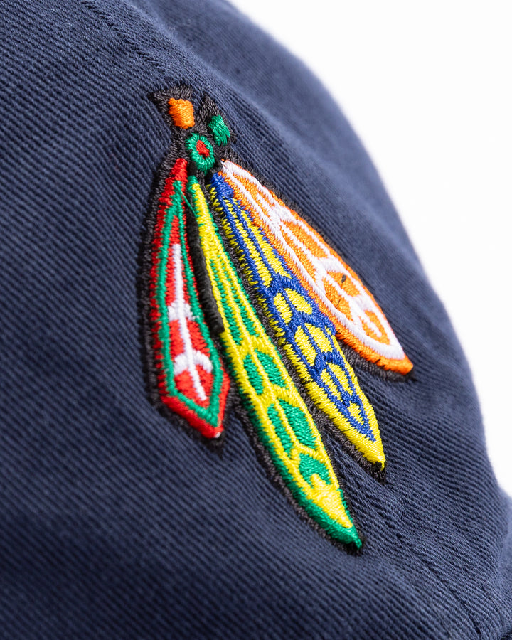 navy '47 brand adjustable hat with Chicago Blackhawks four feather logo embroidered on front and University of Michigan logo embroidered on right side - front detail lay flat