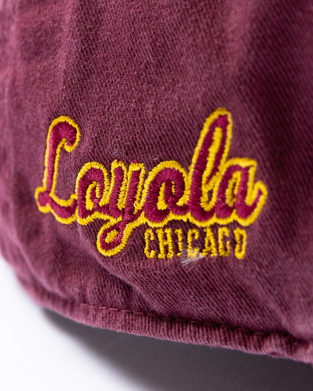 maroon '47 brand adjustable hat with Chicago Blackhawks four feathers logo embroidered on front and Loyola University Chicago logo embroidered on right side - Loyola University Chicago logo detail lay flat