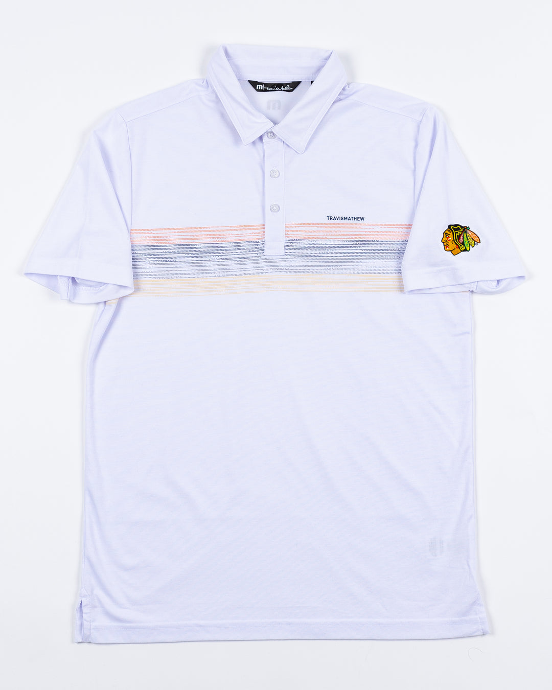 white TravisMathew polo with multicolor stripes and embroidered Chicago Blackhawks primary logo on left shoulder - front lay flat