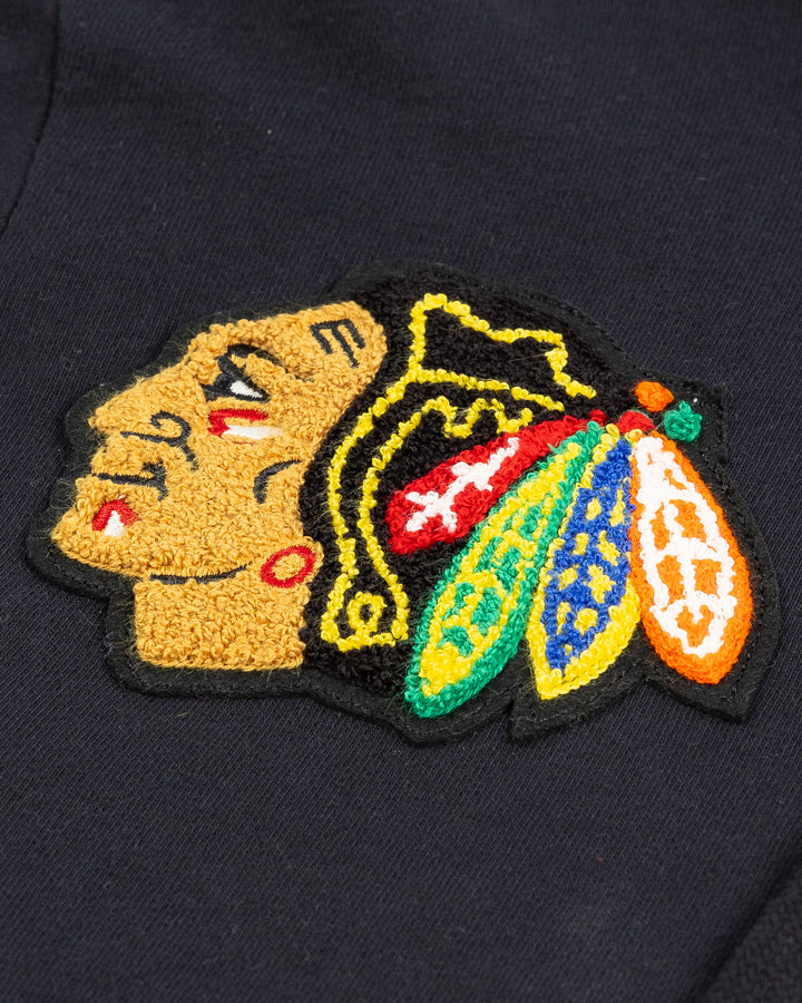 ribbed black Mitchell & Ness hoodie with embroidered chenille Chicago Blackhawks primary and secondary logos on chest - detail lay flat