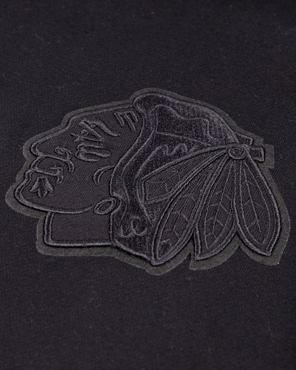 black Pro Standard hoodie with tonal Chicago Blackhawks patches throughout - front patch detail lay flat