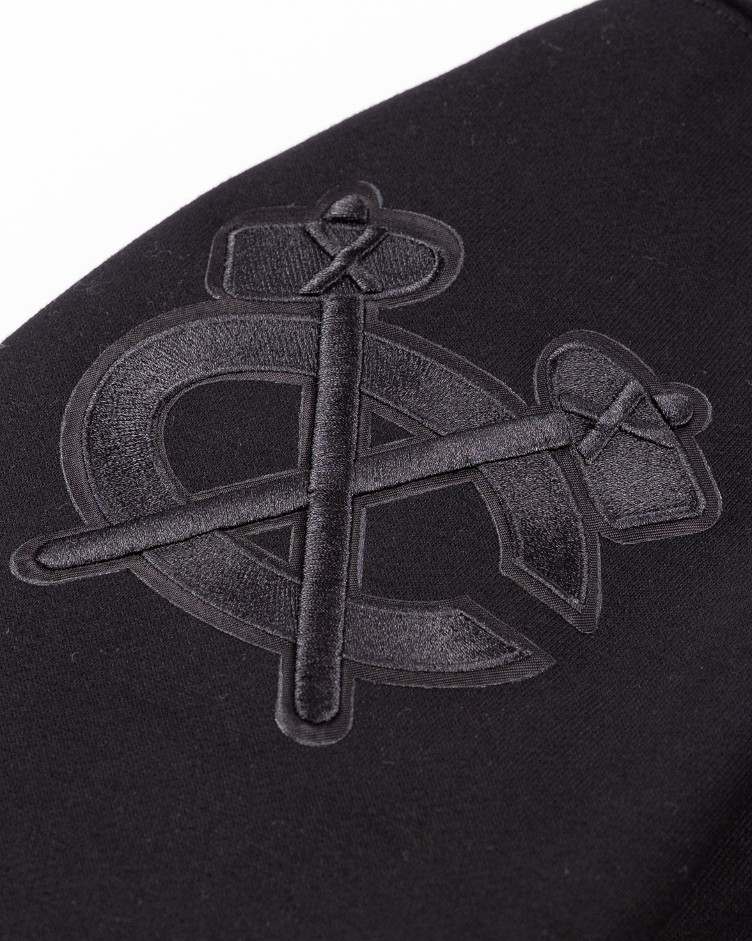 black Pro Standard hoodie with tonal Chicago Blackhawks patches throughout - shoulder detail lay flat