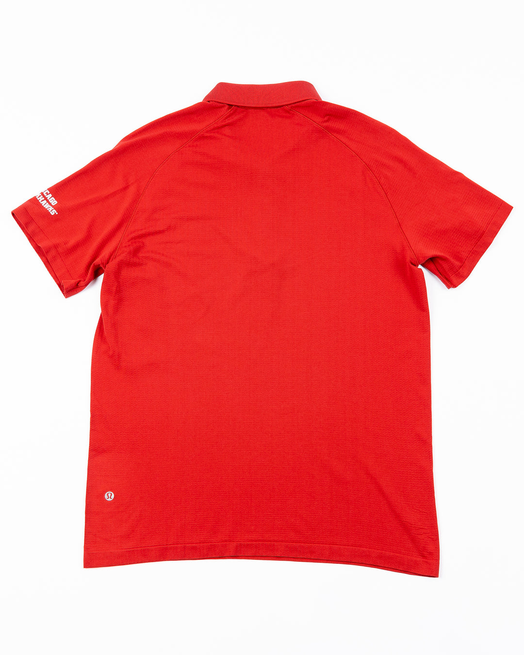 red lululemon polo with Chicago Blackhawks wordmark on left shoulder - back lay flat