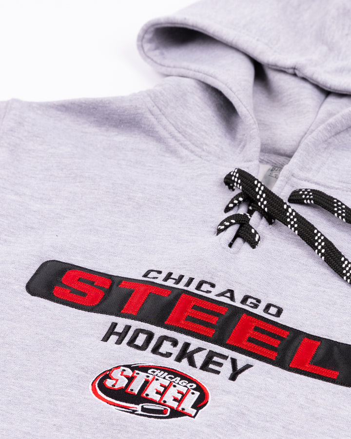 grey youth hoodie with lace up front and Chicago Steel Hockey graphic across front - detail lay flat