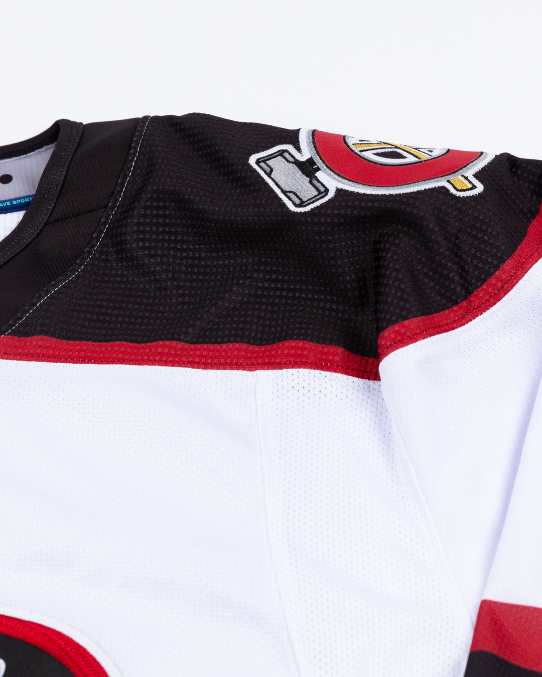 white Chicago Steel replica hockey jersey - shoulder detail lay flat