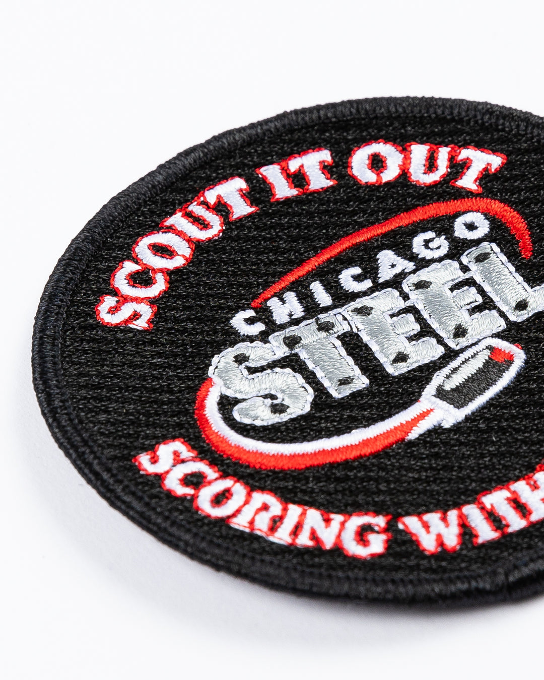 black round patch with Chicago Steel logo and Scout it Out Scoring with the Steel embroidered - detail lay flat