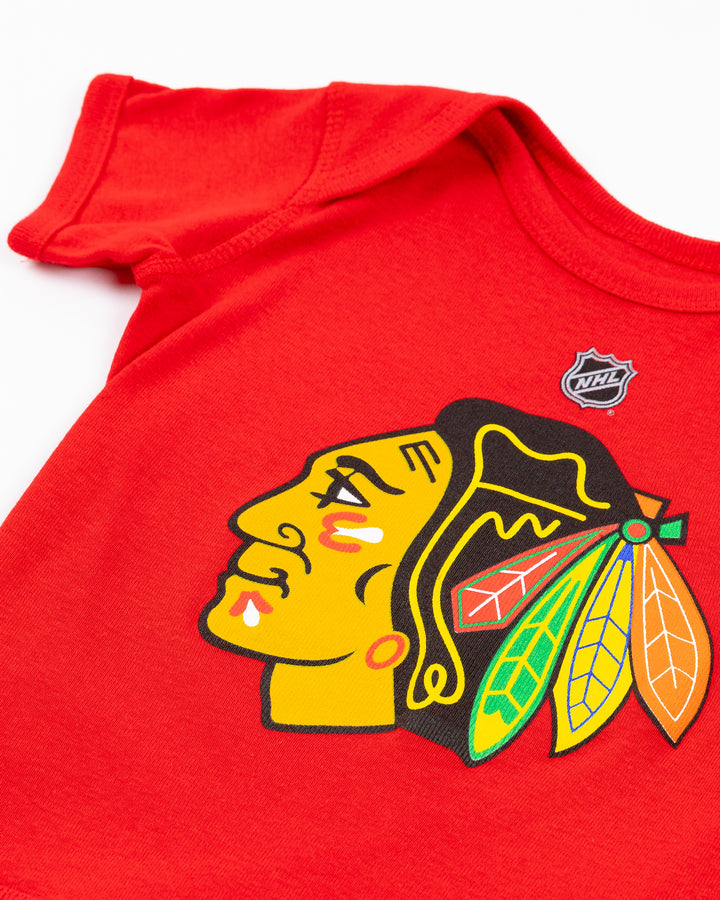 red Chicago Blackhawks newborn onesie with primary logo across front - detail lay flat