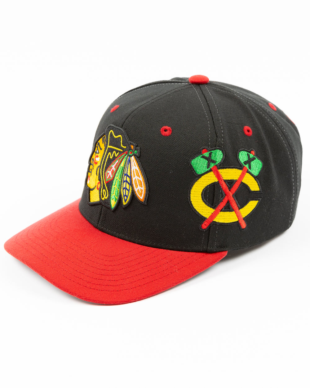 black and red Mitchell & Ness snapback with Chicago Blackhawks primary logo on front, secondary logo on left side and wordmark Chicago on right - left angle lay flat