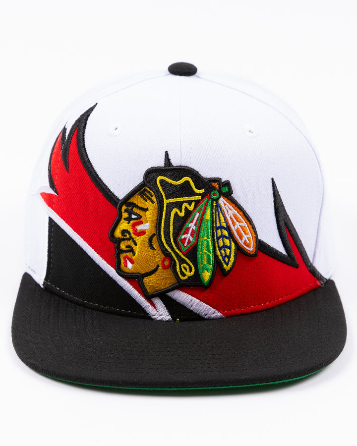 white and black Mitchell & Ness snapback cap with embroidered Chicago Blackhawks primary logo on wave design - front lay flat