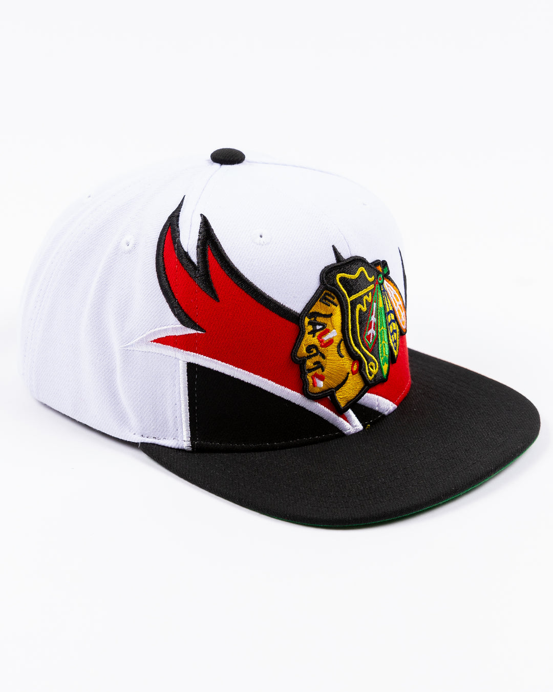 white and black Mitchell & Ness snapback cap with embroidered Chicago Blackhawks primary logo on wave design - right angle lay flat