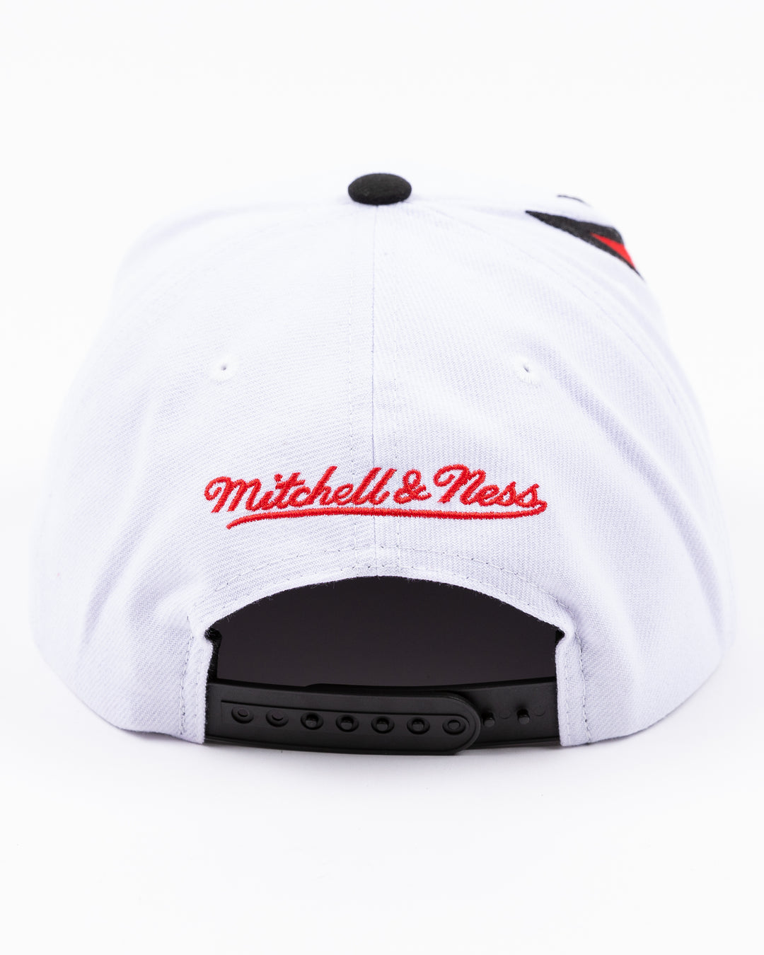 white and black Mitchell & Ness snapback cap with embroidered Chicago Blackhawks primary logo on wave design - back lay flat