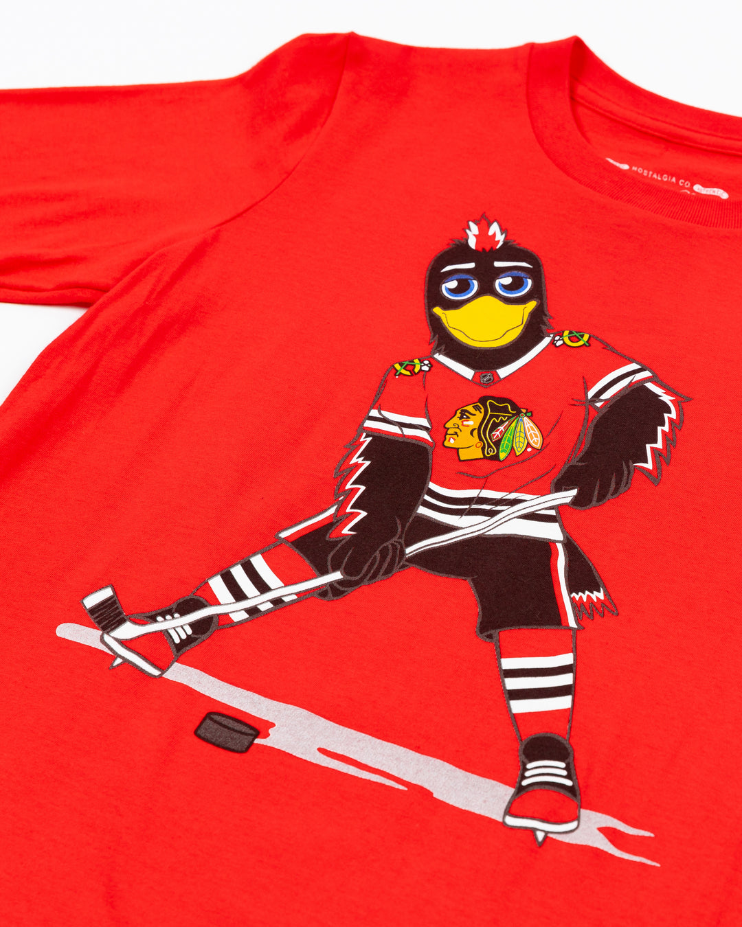 red Mitchell & Ness youth short sleeve tee with Chicago Blackhawks mascot Tommy Hawk on front - detail lay flat