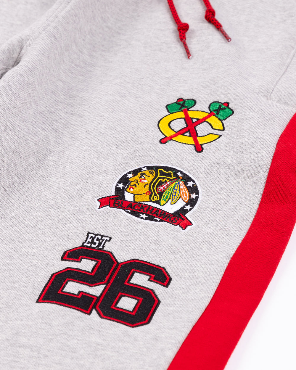 grey New Era sweatpants with embroidered Chicago Blackhawks logos and 26 on left leg - detail  lay flat