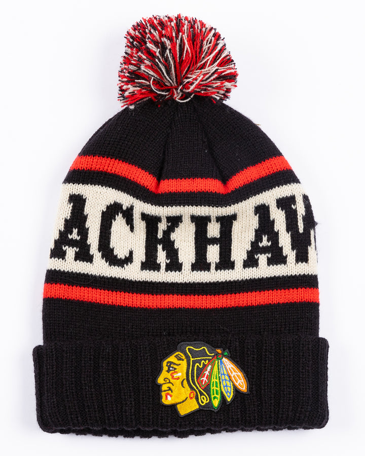 American Needle black knit pom hat with Chicago Blackhawks wordmark on front and embroidered primary logo on front cuff - front lay flat