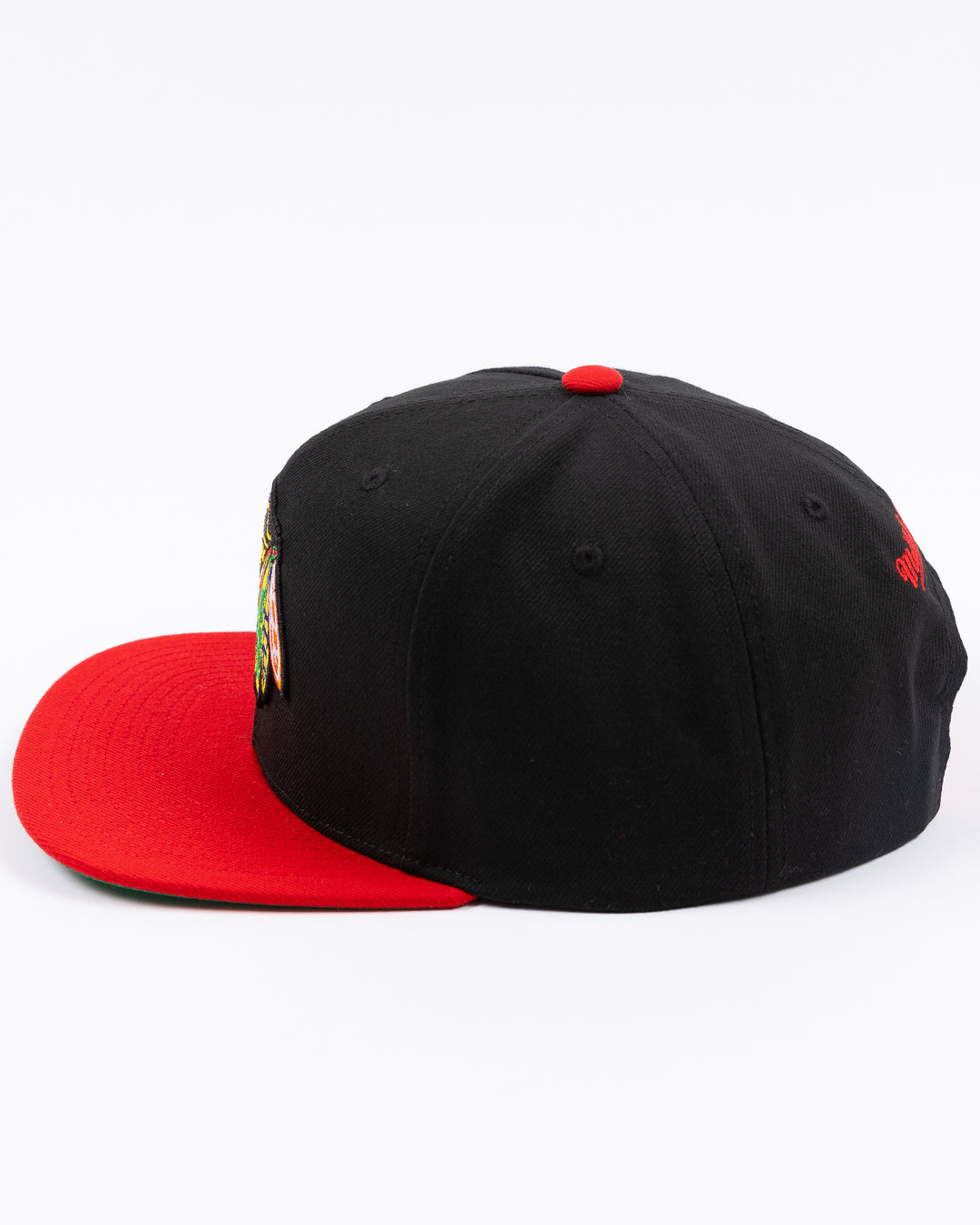 two tone red and black Mitchell &amp; Ness snapback with embroidered primary logo on front - left side lay flat