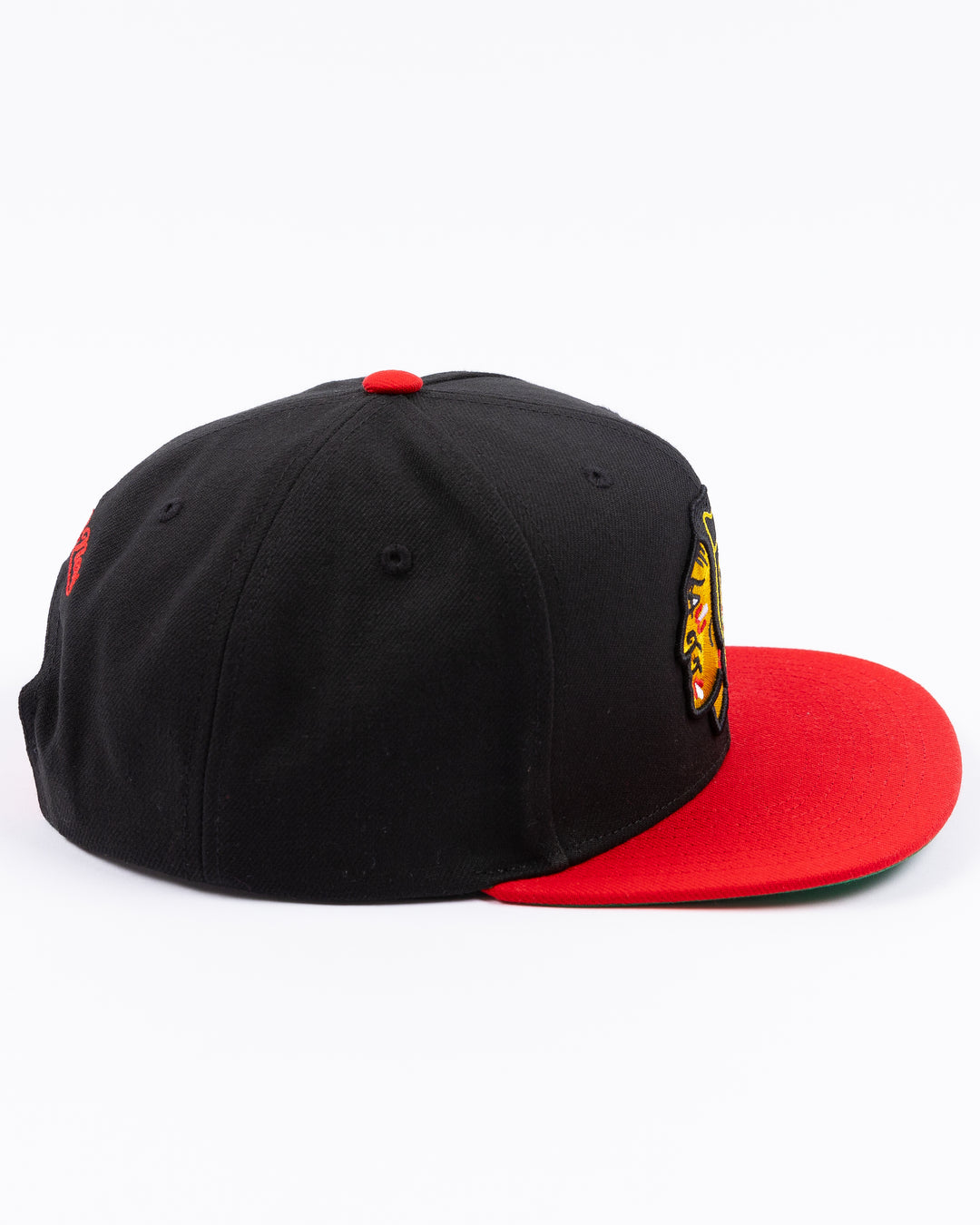 two tone red and black Mitchell &amp; Ness snapback with embroidered primary logo on front - right side lay flat