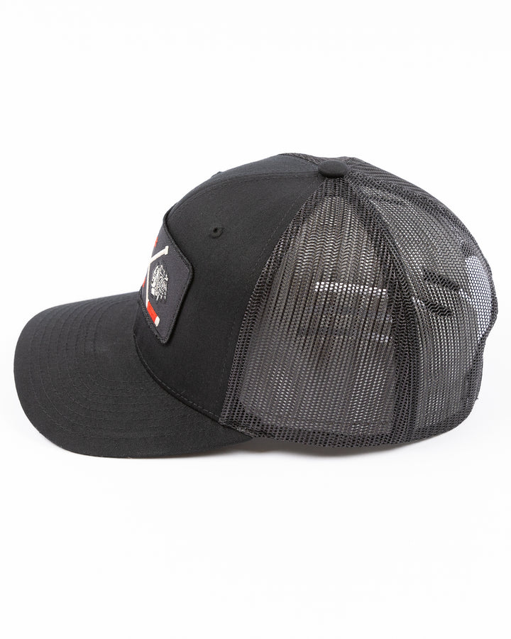 black trucker hat with patch of Windy City Smokeout logo and Chicago Blackhawks primary logo on front - left side lay flat