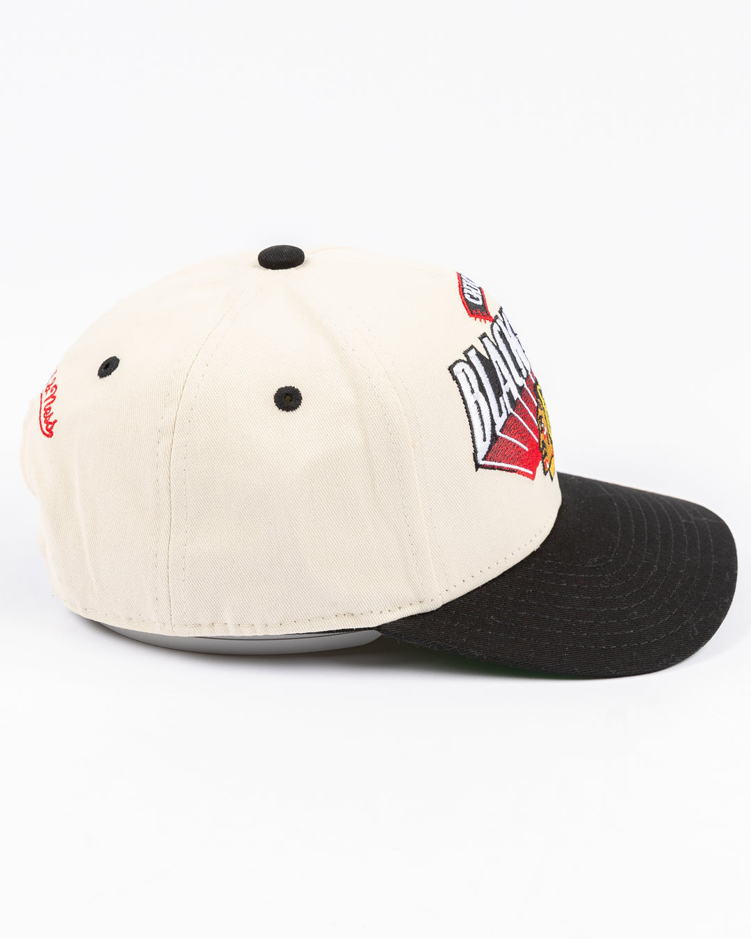 youth cream and black Mitchell & Ness snapback cap with Chicago Blackhawks wordmark and primary logo on front - right side lay flat