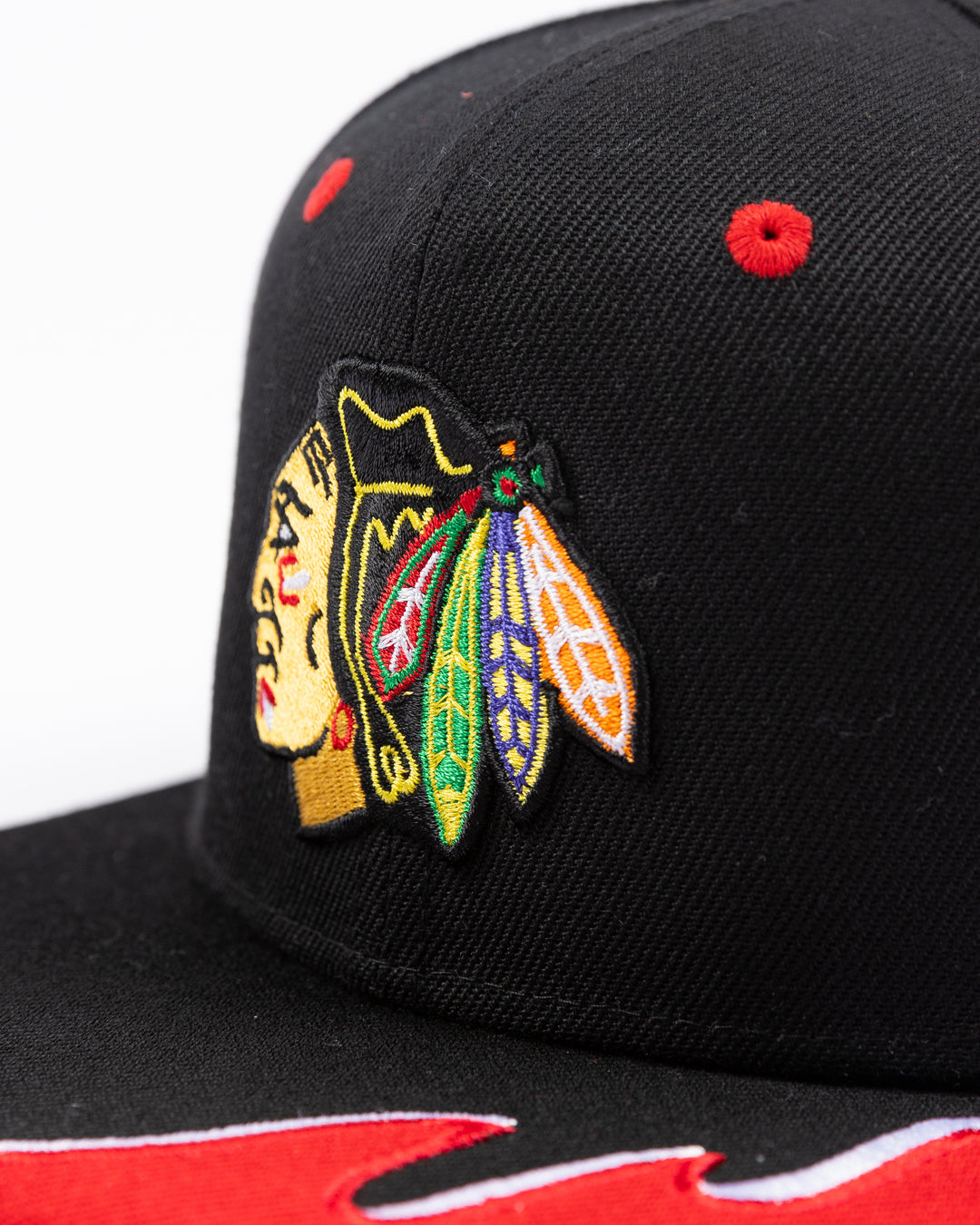 youth black MItchell & Ness snapback cap with Chicago Blackhawks primary logo on front and tide design embroidered on brim and left side - detail lay flat