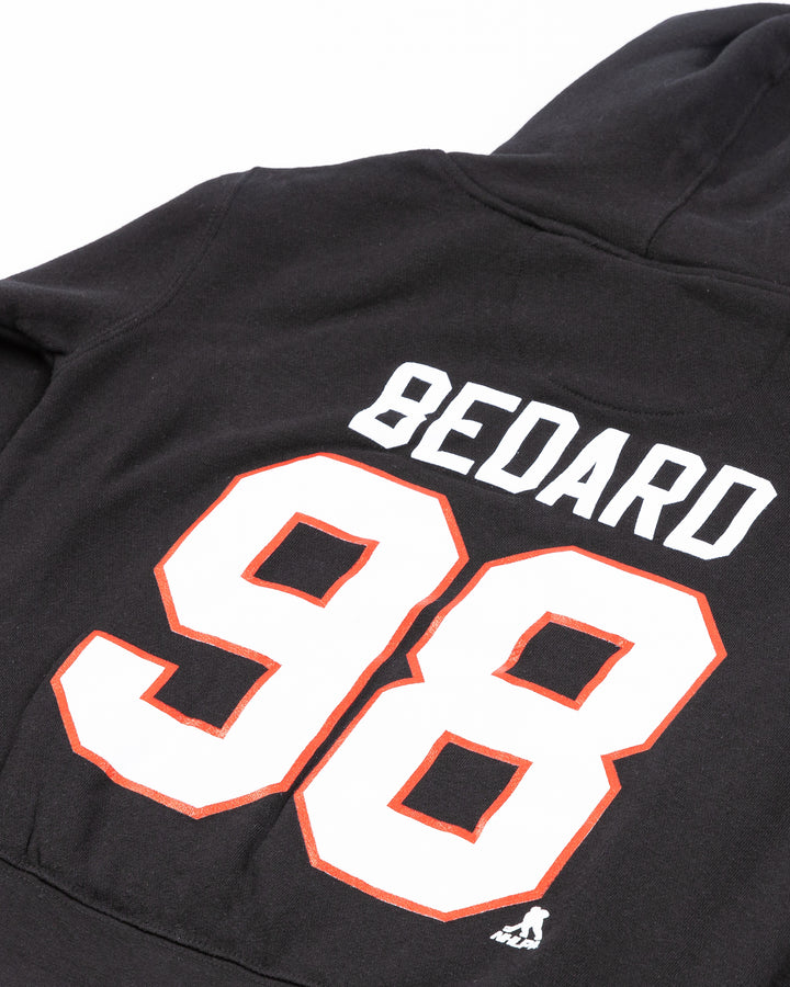 youth black hoodie with Connor Bedard name and number on back and Chicago Blackhawks primary logo on front - back detail lay flat