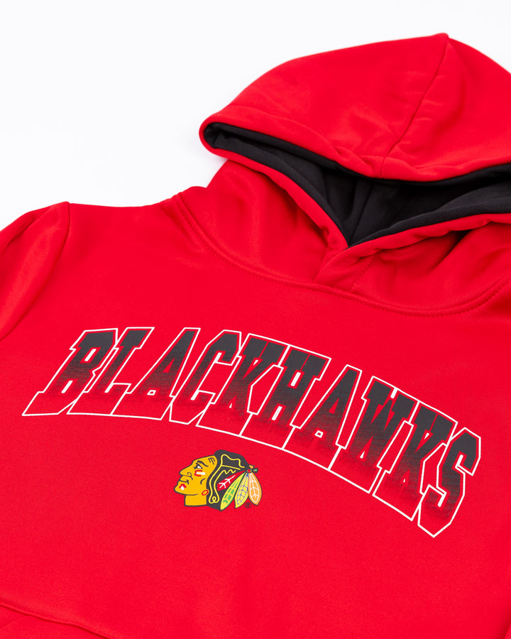 red Colosseum youth hoodie with Chicago Blackhawks wordmark and primary logo across front and Chicago wordmark on kangaroo pocket seam - front detail lay flat