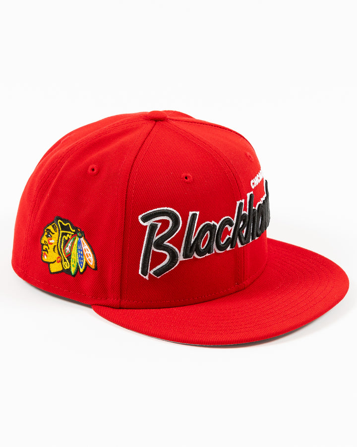 red New Era 9FIFTY snapback cap with Chicago Blackhawks wordmark on front and primary logo on right side - right angled lay flat