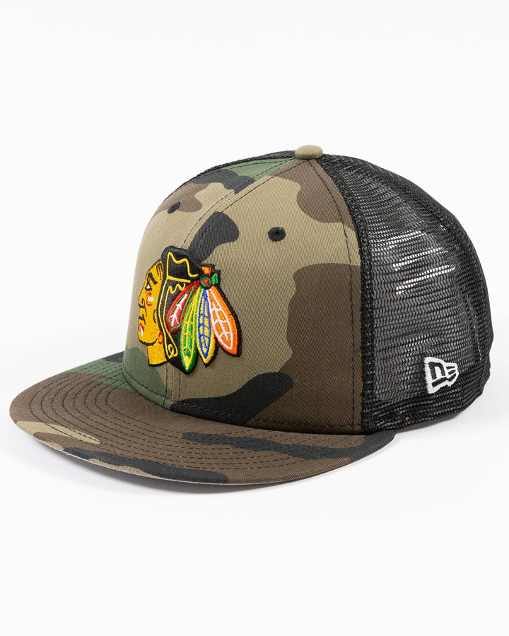 camo New Era 9FIFTY adjustable snapback cap with Chicago Blackhawks primary logo embroidered on front - left angle lay flat