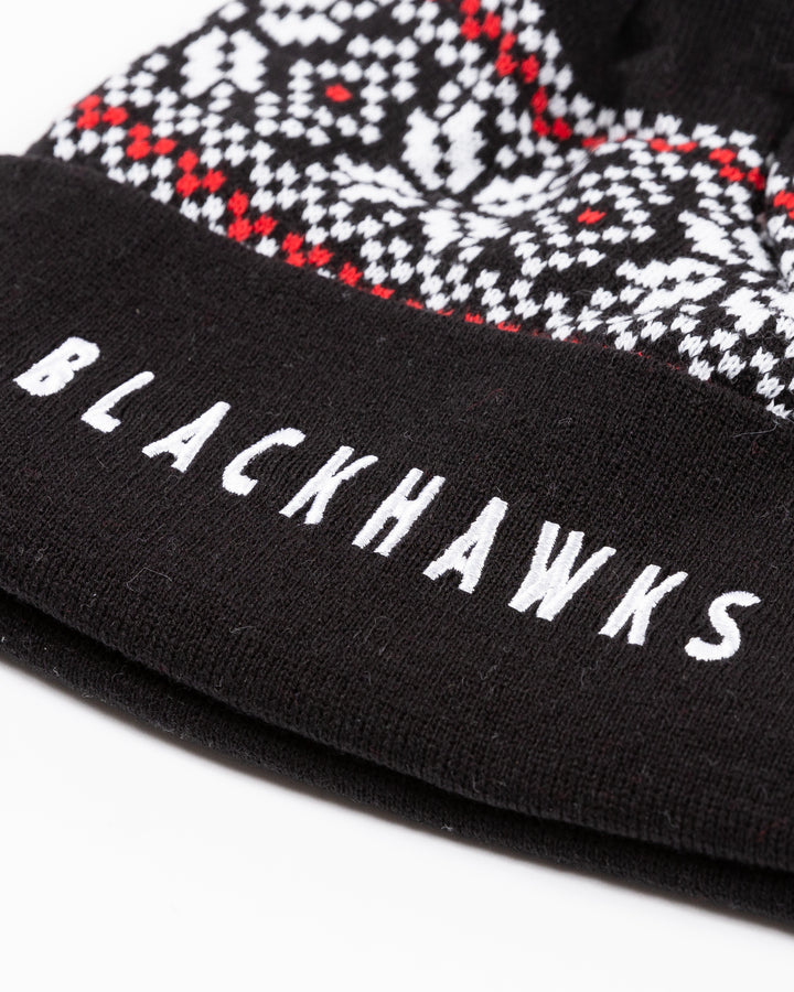 black CCM knit hat with pom with fair isle sweater pattern detail and embroidered Blackhawks wordmark on front cuff - detail lay flat