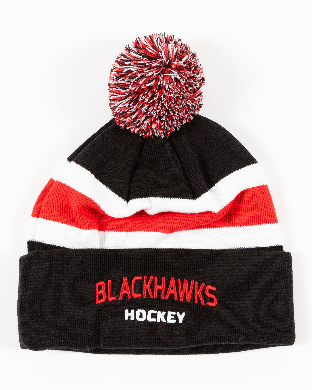 black CCM knit beanie with red and white stripe on front and embroidered Blackhawks Hockey wordmark on front cuff with multicolor pom on top - front lay flat