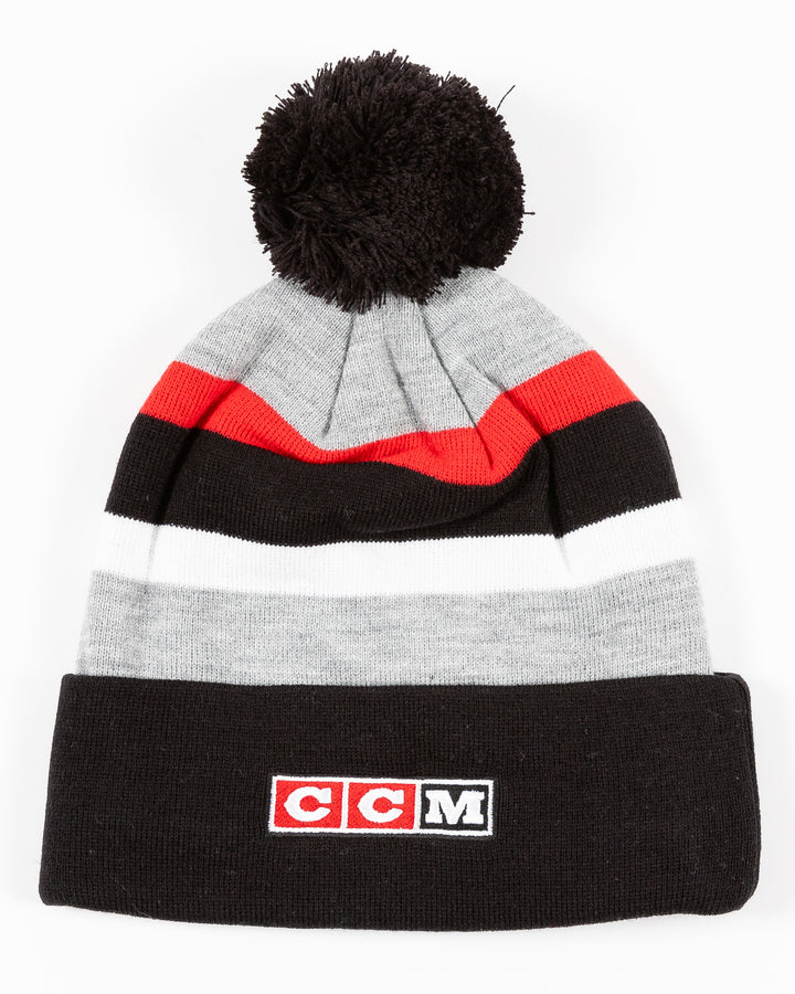 striped CCM knit hat with pom with Chicago Blackhawks primary logo embroidered on front cuff - back lay flat