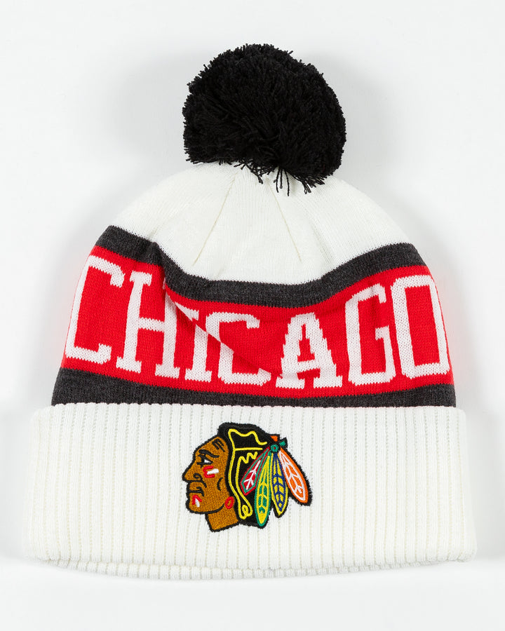 white CCM knit hat with pom with Chicago wordmark on front and Chicago Blackhawks primary logo embroidered on front cuff - front lay flat