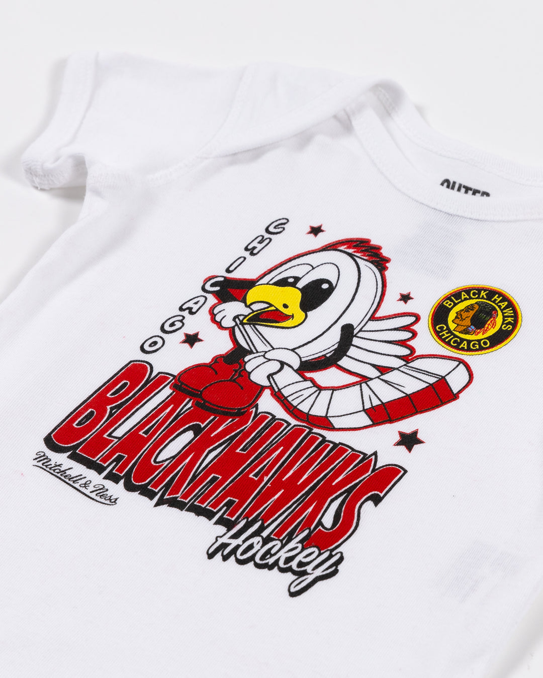 white Mitchell & Ness newborn onesie with Chicago Blackhawks Tommy puck graphic across front - front detail lay flat