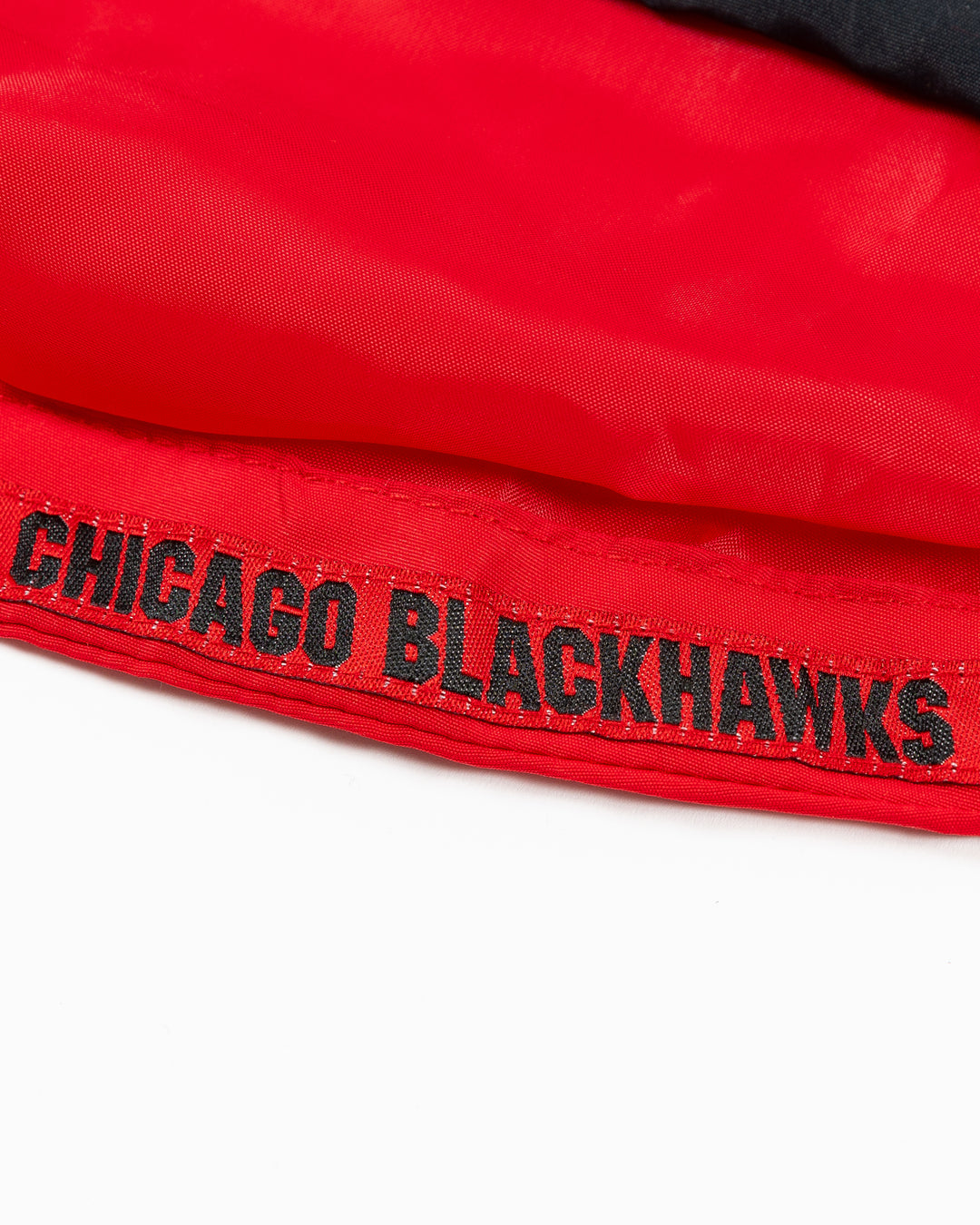 red Colosseum half zip hoodie jacket with Chicago Blackhawks primary logo on left chest and Blackhawks wordmark on shoulder on right arm - detail lay flat