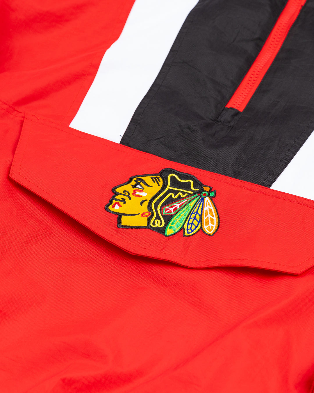 color blocked red, black and white half zip Starter jacket with hood with Chicago Blackhawks primary logo adorning front pocket and back - front detail lay flat