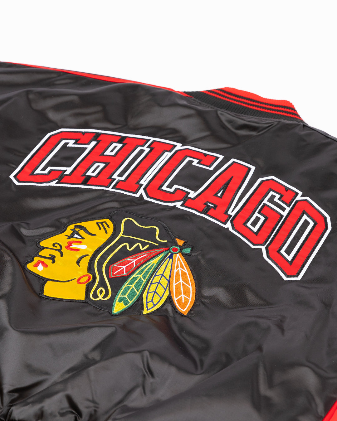 two tone red and black women's Starter jacket with Blackhawks wordmark on front and Chicago wordmark on back with Chicago Blackhawks primary logo - back detail lay flat