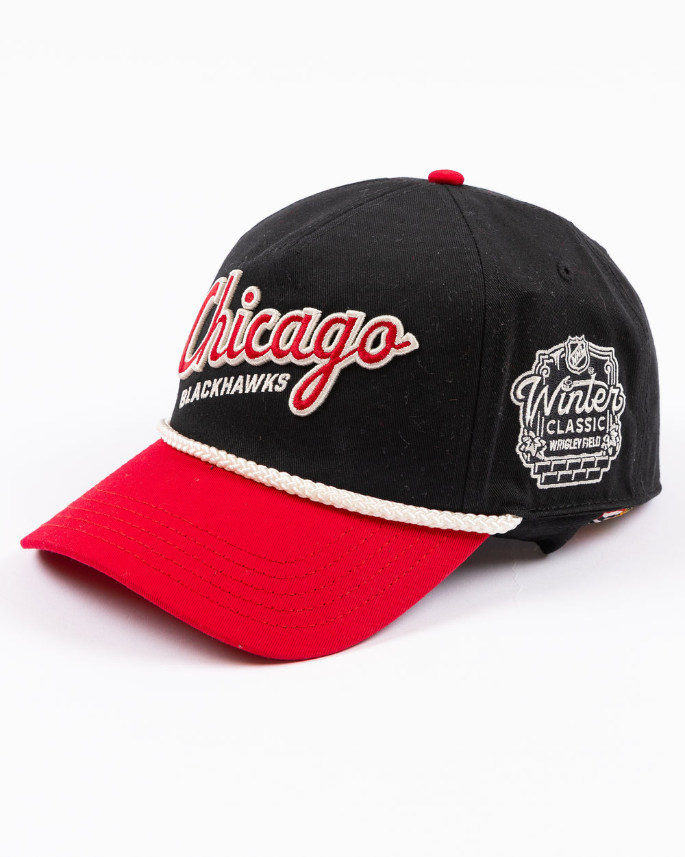 two tone black and red rope American Needle snapback cap with Chicago Blackhawks wodmark embroidered on front and Winter Classic logo embroidered on left side - left angle lay flat