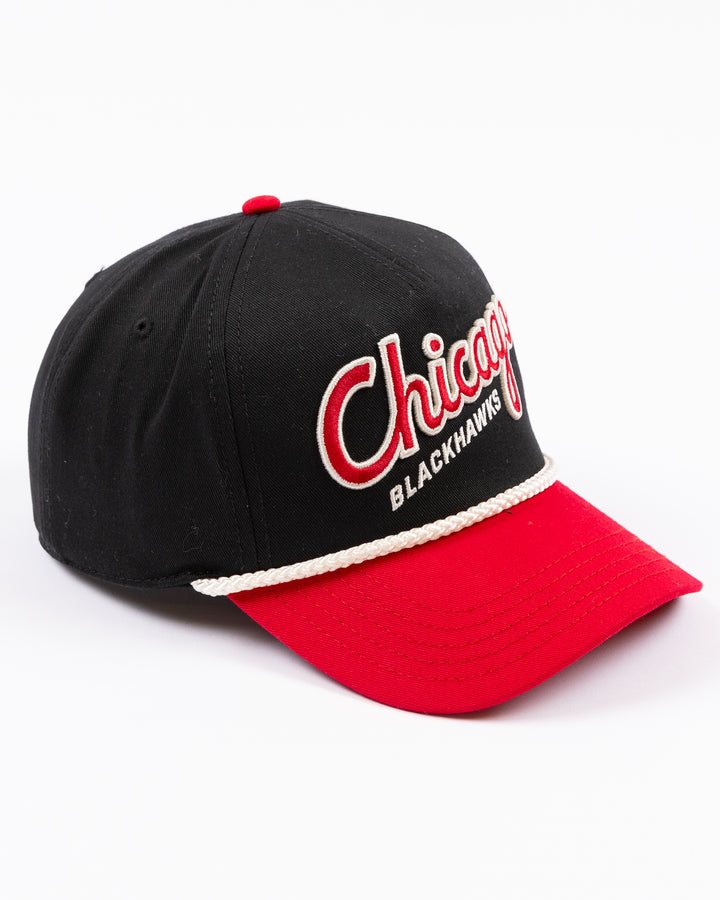 two tone black and red rope American Needle snapback cap with Chicago Blackhawks wodmark embroidered on front and Winter Classic logo embroidered on left side - right angle lay flat