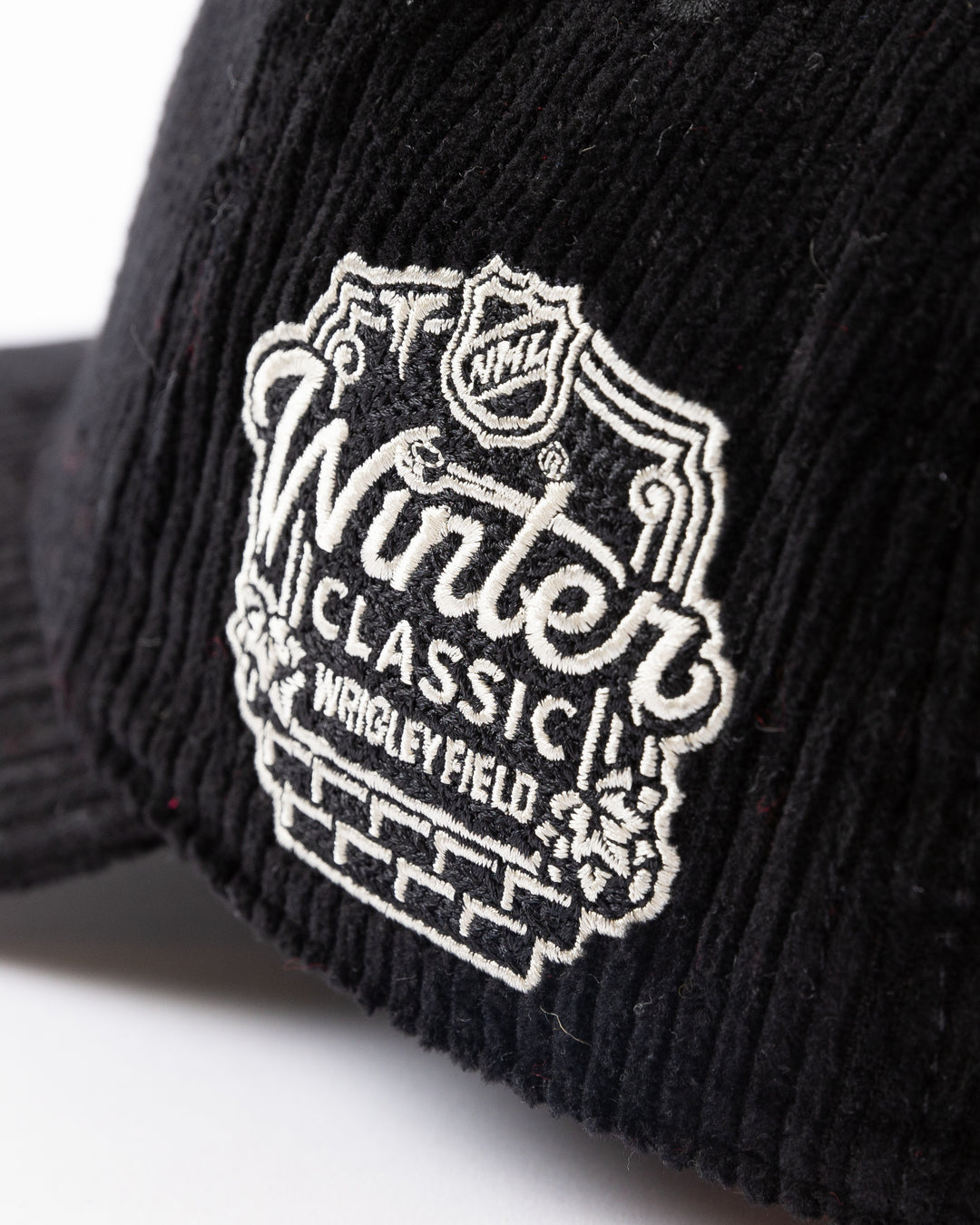 black corduroy American Needle snapback cap with Chicago Blackhawks Winter Classic logo on front and NHL Winter Classic logo on left side - side detail lay flat