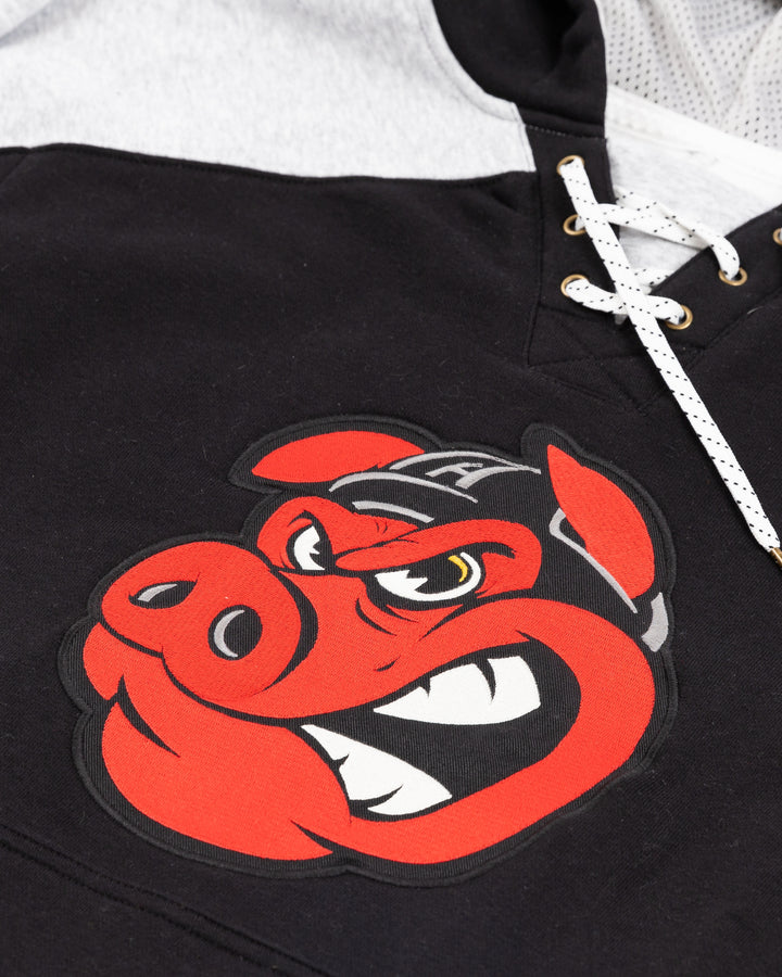 black jersey-inspired CCM hoodie with Rockford IceHogs Hammy embroidered on front - front detail lay flat