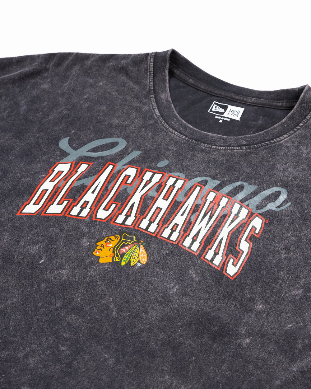 washed black short sleeve New Era ladies tee with scripted Chicago Blackhawks wordmark graphic across front above primary logo - front detail lay flat