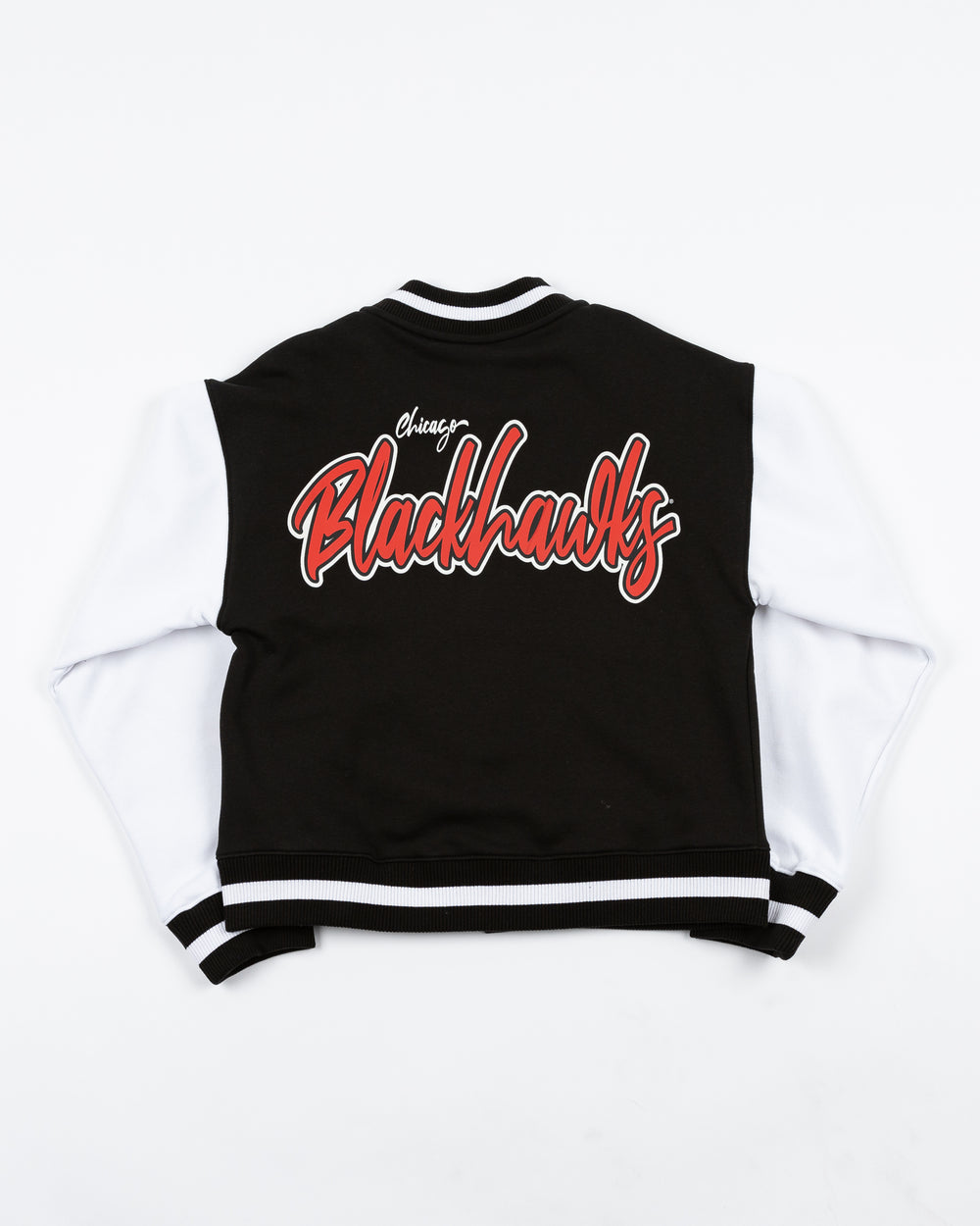 black and white ladies New Era varsity jacket with Chicago Blackhawks primary logo on left chest and Blackhawks wordmark on back - back lay flat