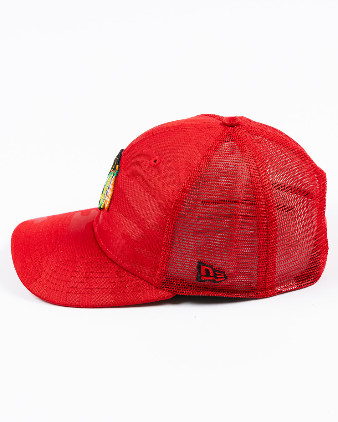 red camo New Era trucker cap with embroidered Chicago Blackhawks primary logo on front - left side lay flat